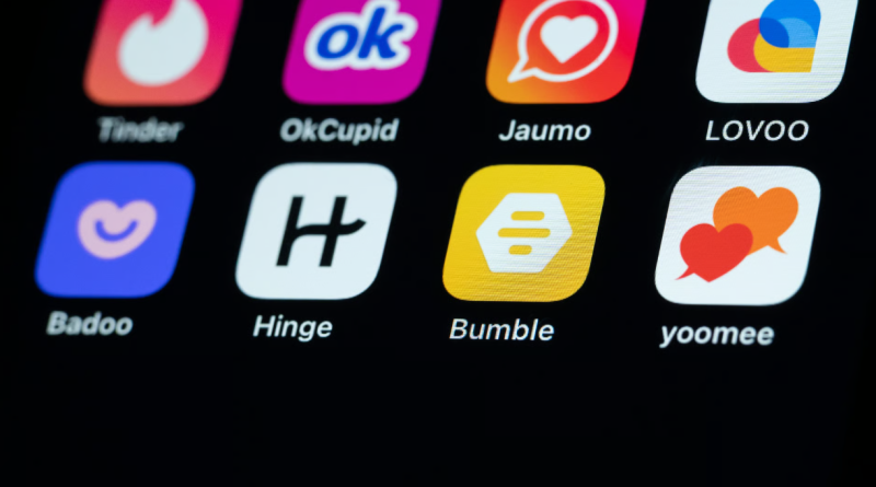 Dating app icons including Tinder, OkCupid, Hinge and Bumble on a smartphone screen.