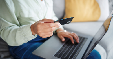 UK dating app subscription rules illustrated by a woman holding a payment card while using a laptop